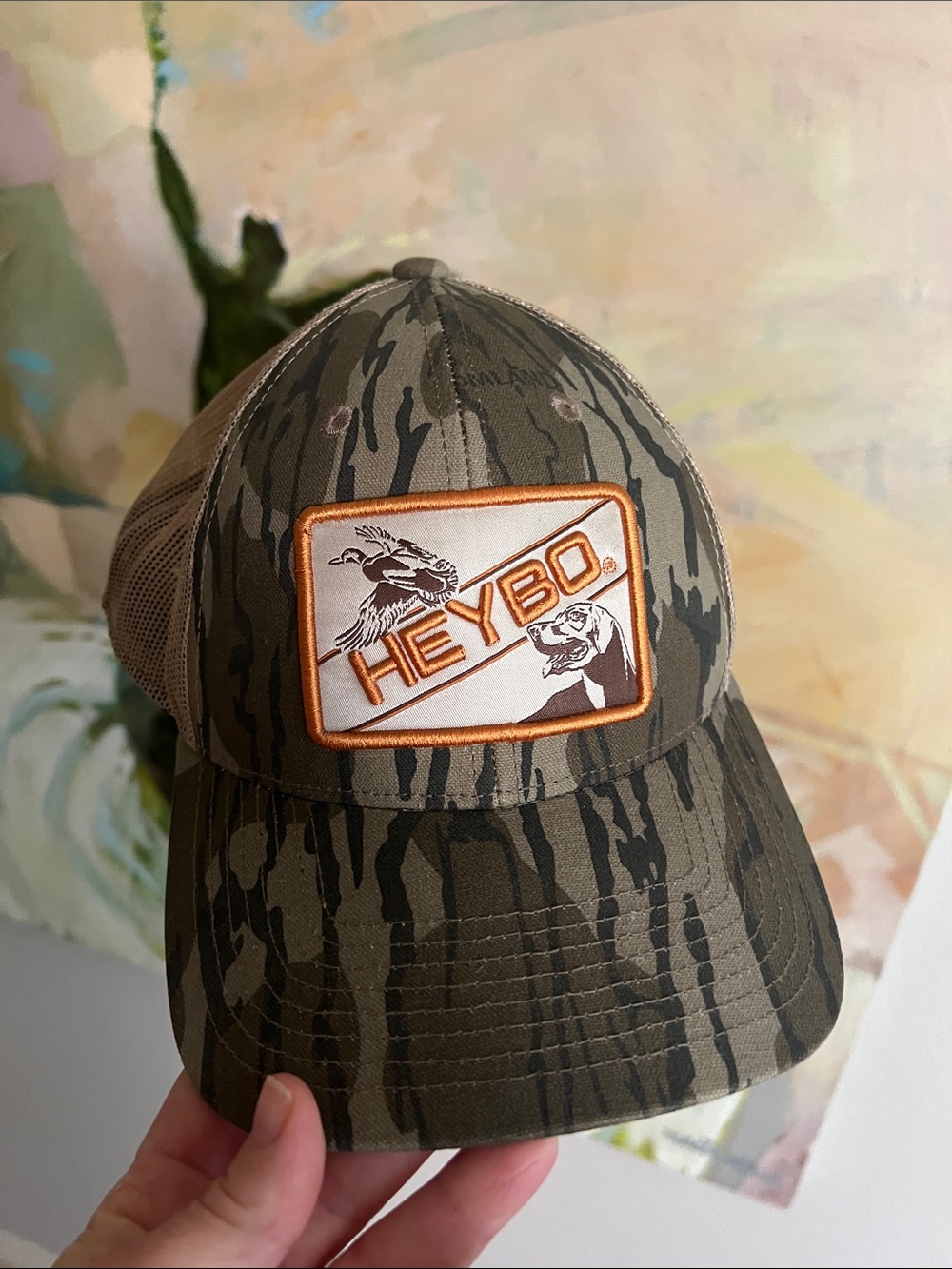 Heybo Outdoors trucker hat with Mallard/Lab patch logo Mossy Oak Bottomland camo